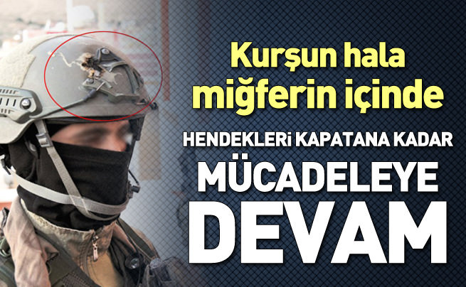 Asker, kendisini ölümden kurtaran miğferiyle nöbette